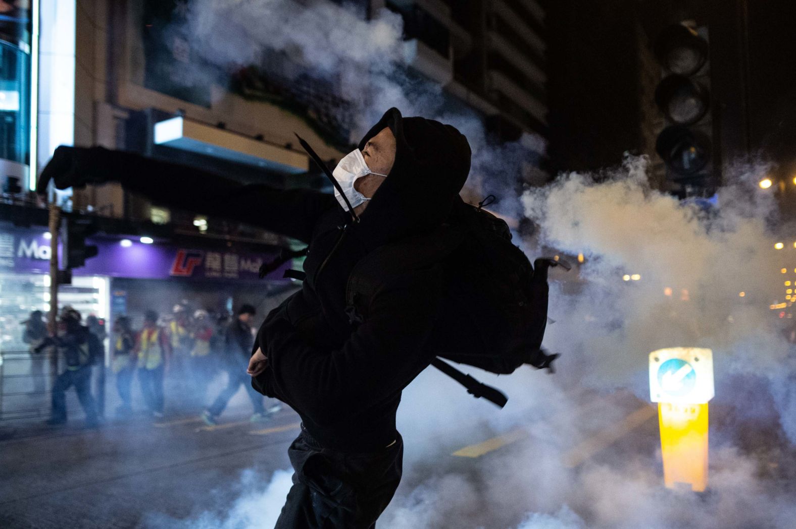 A protester reacts after police fire tear gas to disperse bystanders in the Jordan district of Hong Kong, early on December 25.