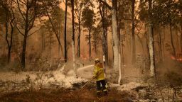 A firefighter sprays foam retardant on a back burn ahead of a fire front in the New South Wales town of Jerrawangala on January 1, 2020. - A major operation to reach thousands of people stranded in fire-ravaged seaside towns was under way in Australia on January 1 after deadly bushfires ripped through popular tourist spots and rural areas leaving at least eight people dead. (Photo by PETER PARKS / AFP) (Photo by PETER PARKS/AFP via Getty Images)