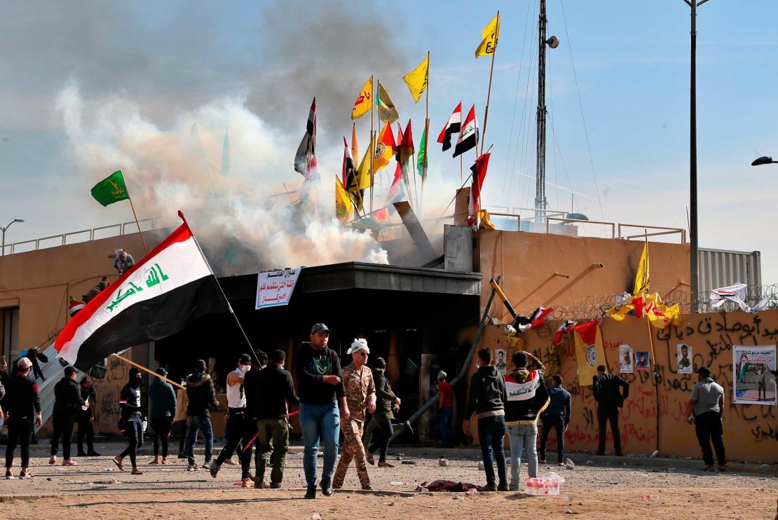 Pro-Iranian militiamen and their supporters set a fire while U.S. soldiers fired tear gas during a sit-in in front of the U.S. embassy in Baghdad.