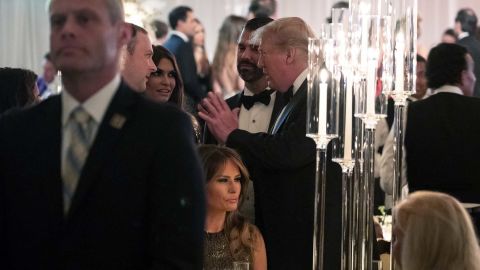 President Donald Trump, standing center, talks with guests during his New Year's Eve party at his Mar-a-Lago property, Tuesday, Dec. 31, 2019, in Palm Beach, Florida.
