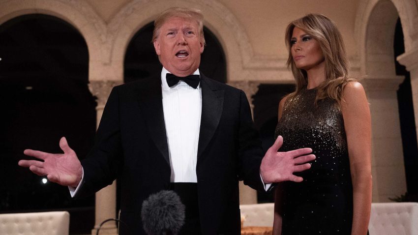 US President Donald Trump and First Lady Melania Trump speak to the press outside the grand ballroom as they arrive for a New Year's celebration at Mar-a-Lago in Palm Beach, Florida, on December 31, 2019. (Photo by JIM WATSON / AFP) (Photo by JIM WATSON/AFP via Getty Images)