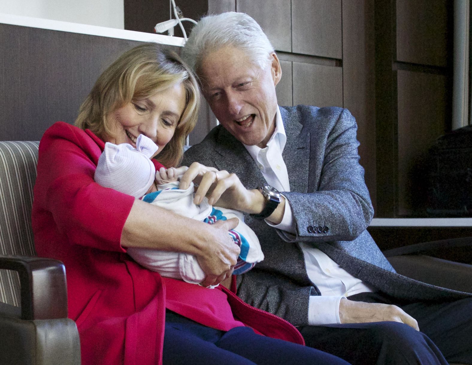 The Clintons hold their granddaughter, Charlotte, at a New York hospital in September 2014.