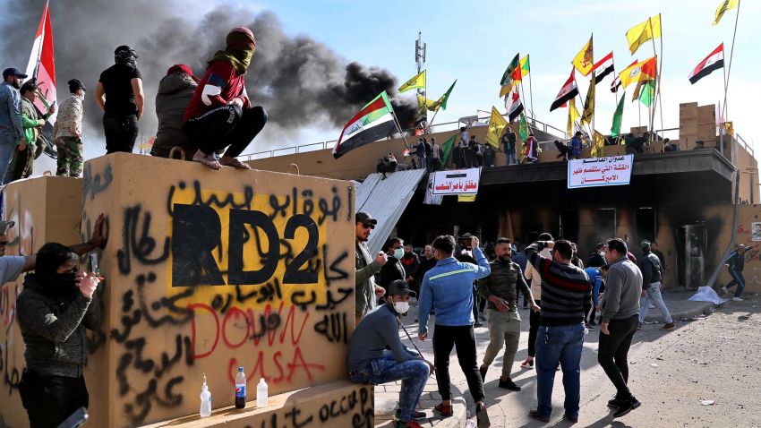 Pro-Iranian militiamen and their supporters set a fire during a sit-in in front of the U.S. embassy in Baghdad, Iraq, Wednesday, Jan. 1, 2020. U.S. troops fired tear gas on Wednesday to disperse pro-Iran protesters who were gathered outside the U.S. Embassy compound in Baghdad for a second day as pro-Iranian militiamen and their supporters had camped out overnight at the gates of the embassy. On Tuesday, dozens of the protesters had broken into the compound, trashing a reception area and smashing windows in one of the worst attacks on the embassy in recent memory. (AP Photo/Khalid Mohammed)