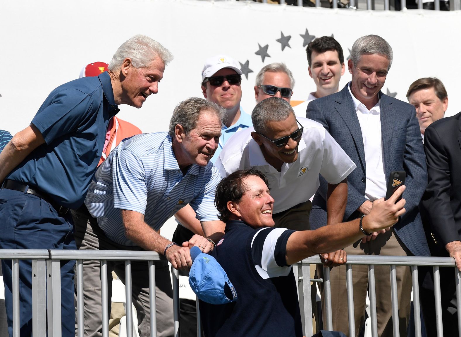 Clinton and former Presidents George W. Bush and Barack Obama pose for a selfie with golfer Phil Mickelson during the Presidents Cup event in September 2017.