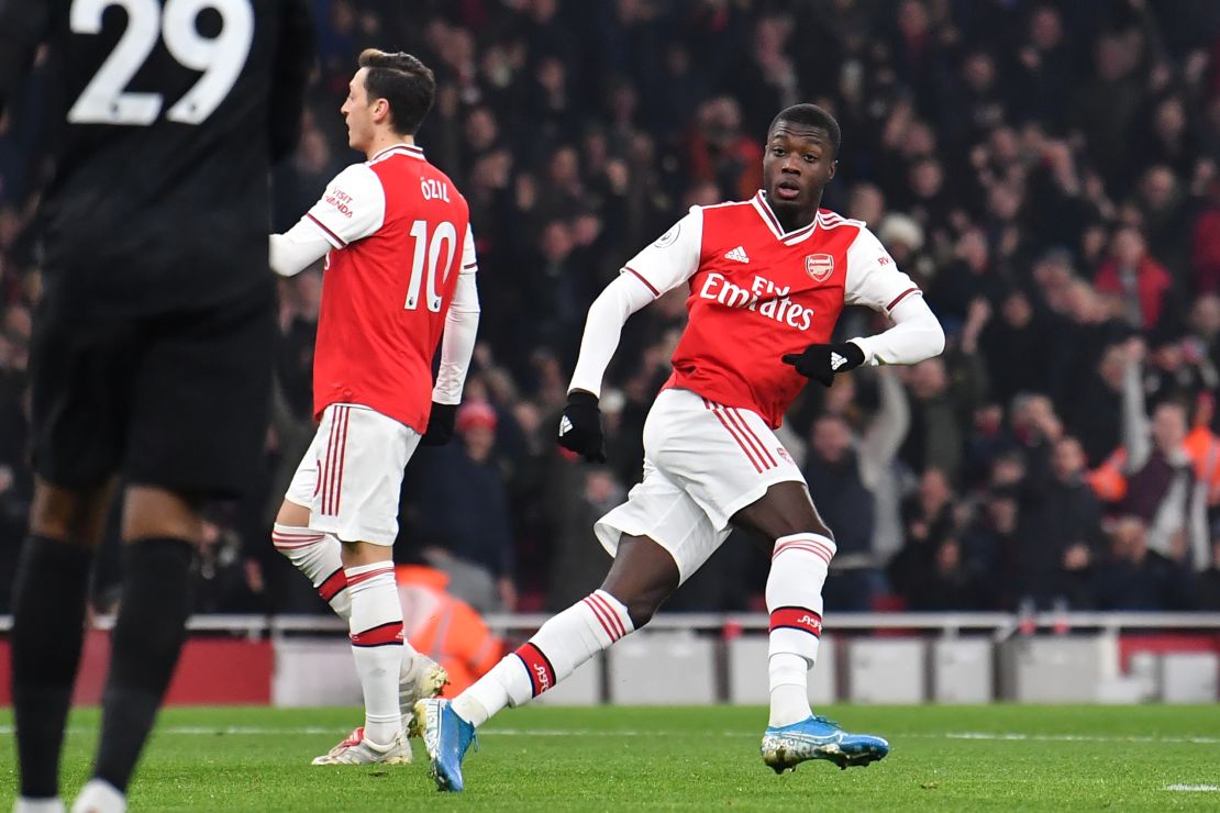 Arsenal's French-born Ivorian midfielder Nicolas Pepe turns to celebrate after scoring the opening goal of the English Premier League game against Manchester United.
