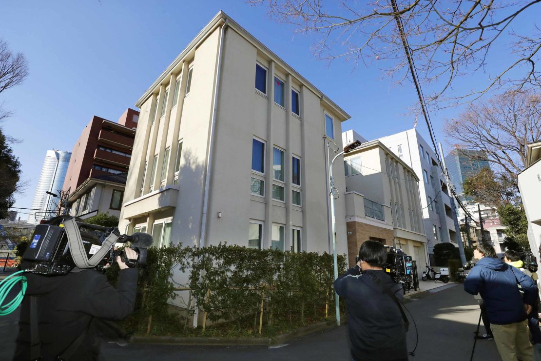 Journalists wait outside former Nissan Chairman Carlos Ghosn's residence before a raid in Tokyo Thursday, Jan. 2, 2020.