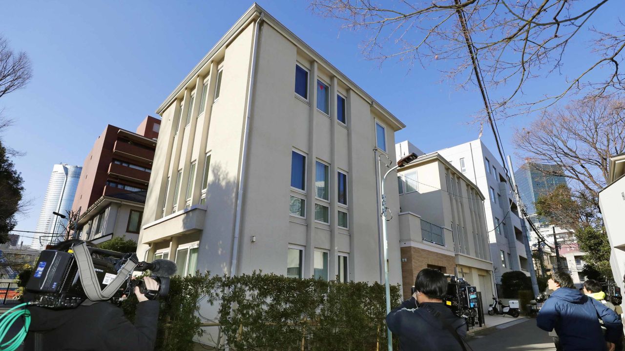 Journalists wait outside former Nissan Chairman Carlos Ghosn's residence before a raid in Tokyo Thursday, Jan. 2, 2020.