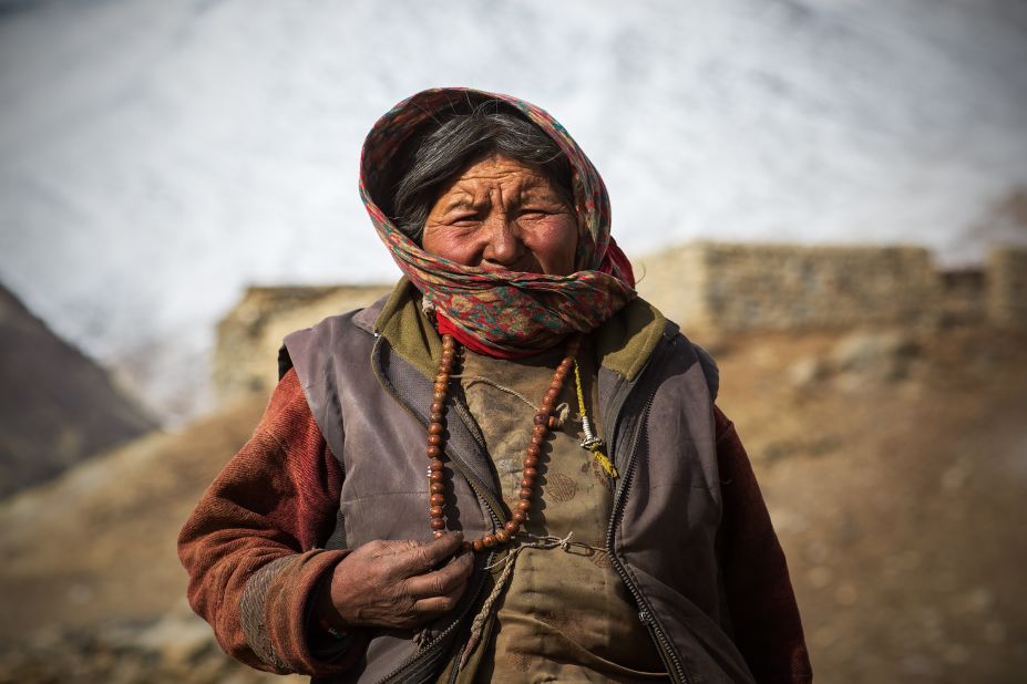 A village elder wrapped up against the bitter plateau winds.