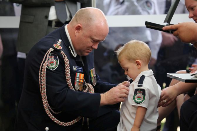 Royal Fire Service Commissioner Shane Fitzsimmons presents a posthumous Commendation for Bravery and Service on January 2 to the son of RFS volunteer Geoffrey Keaton, who was <a href="index.php?page=&url=https%3A%2F%2Fedition.cnn.com%2F2020%2F01%2F02%2Faustralia%2Faustralia-medal-firefighter-son-intl-scli%2Findex.html" target="_blank">killed battling bushfires</a>, at Keaton's funeral in Buxton, New South Wales.