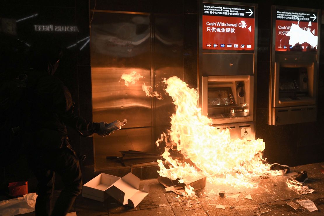 A protester sets fire to an ATM at an HSBC branch in Hong Kong following a pro-democracy march on January 1, 2020.