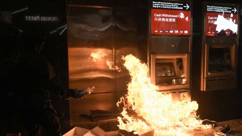 A protester sets fire to an ATM at an HSBC branch in Hong Kong following a pro-democracy march on January 1, 2020.