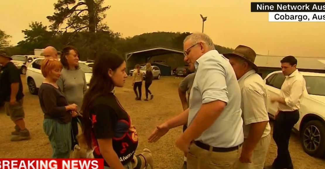 Australian Prime Minister Scott Morrison tries to shake hands with a Cobargo resident.