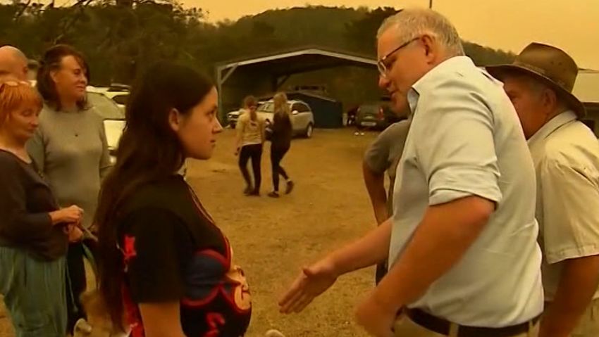 Australian Prime Minister Scott Morrison tries to shake hands with a Cobargo resident.