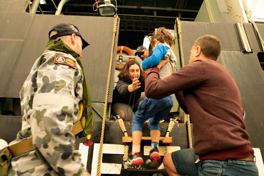 Evacuees board the Royal Australian Navy's MV Sycamore on January 3 in Mallacoota, Victoria, Australia. Navy ships plucked hundreds of people from beaches and tens of thousands were urged to flee before hot weather and strong winds in the forecast worsen Australia's already devastating wildfires. 