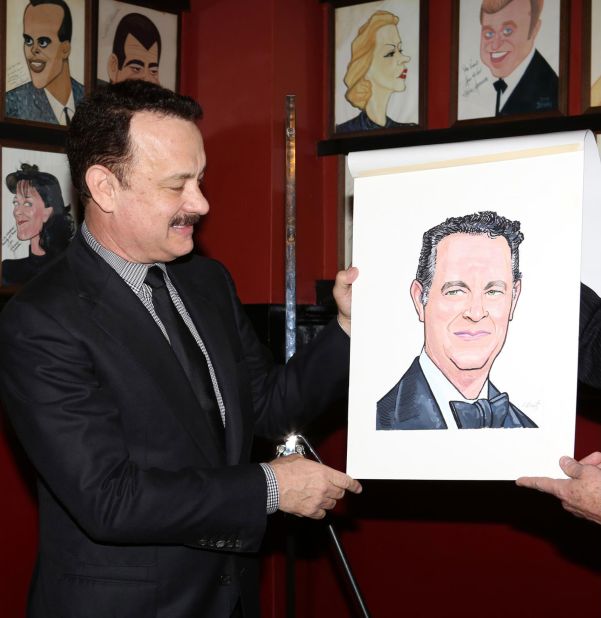 Hanks looks at his caricature after it was unveiled at Sardi's restaurant in New York in 2013.