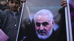 A protester holds a poster with the image of top Iranian commander Qasem Soleimani, who was killed in a US airstrike in Iraq, in the Kashmiri town of Magam on January 3, 2020. - Hundreds of people in Indian Kashmir staged "anti-American" demonstrations in the troubled territory on January 3 within hours of US forces killing a top Iranian commander. (Photo by Tauseef MUSTAFA / AFP) (Photo by TAUSEEF MUSTAFA/AFP via Getty Images)