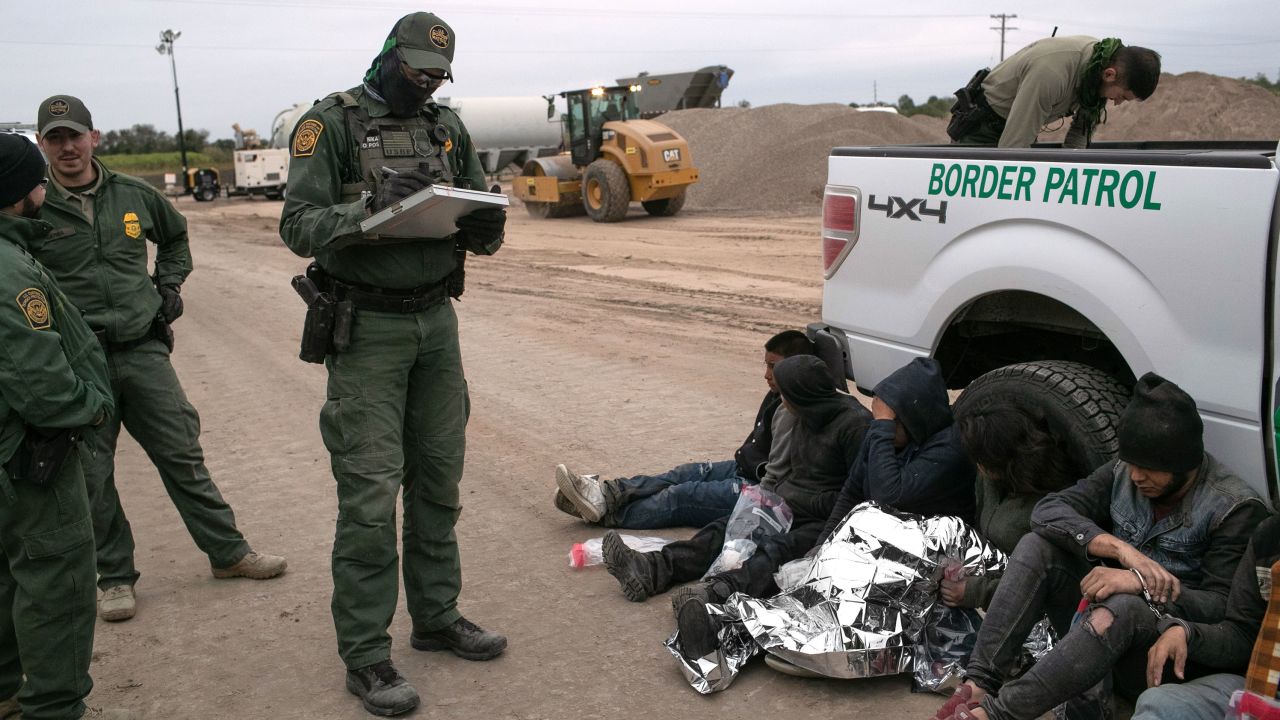 U.S. Border Patrol agents detain undocumented immigrants who they caught near the construction site of a privately-built border wall on December 11, 2019 near Mission, Texas. 