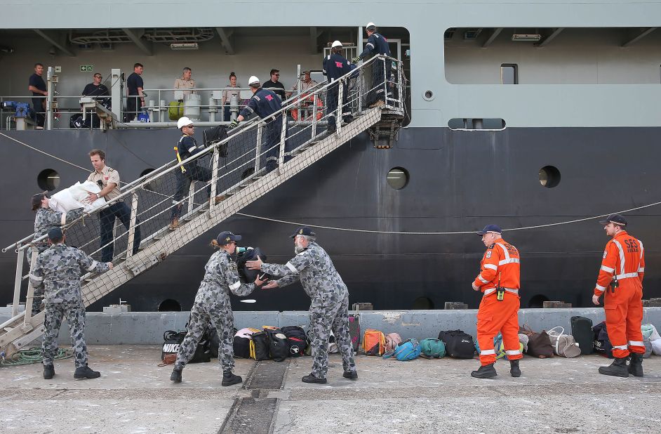 A Royal Australian Navy crew unload luggage as evacuees from Mallacoota arrive aboard the MV Sycamore on January 4 at the port of Hastings, Australia.