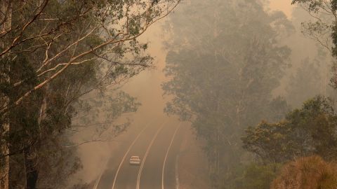 Smoke from wildfires shrouds a road near Moruya, Australia, on January 4.