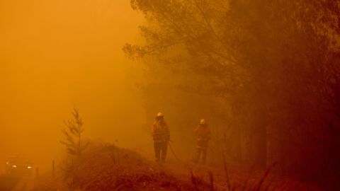 Firefighters tackle a bushfire in thick smoke in the town of Moruya, south of Batemans Bay, in the state of New South Wales on January 4.