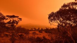 A red sky due to smoke from bushfires hang over the town of Jindabyne in New South Wales on January 4, 2020. - Up to 3,000 military reservists were called up to tackle Australia's relentless bushfire crisis on January 4, as tens of thousands of residents fled their homes amid catastrophic conditions. (Photo by SAEED KHAN / AFP) (Photo by SAEED KHAN/AFP via Getty Images)