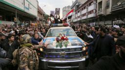 Mourners surround a car carrying the coffin of Iranian military commander Qasem Soleimani, killed alongside Iraqi paramilitary chief Abu Mahdi al-Muhandis in a US air strike.