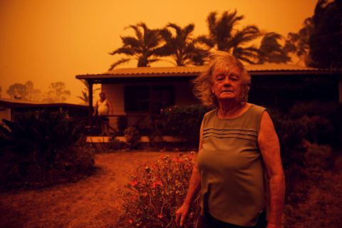 Nancy Allen stands outside her house as high winds push smoke and ash from the Currowan Fire toward Nowra in New South Wales on January 4.