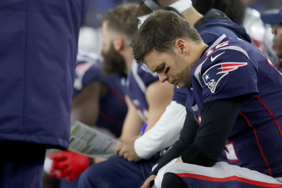 Tom Brady sits on the bench against the Titans in the second quarter of the AFC Wild Card Playoff game.