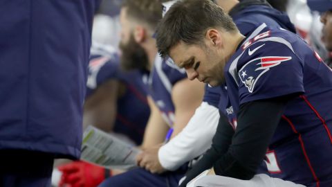 Tom Brady of the New England Patriots sits on the bench against the Tennessee Titans in the second quarter of the AFC Wild Card Playoff game at Gillette Stadium on January 04, 2020 in Foxborough, Massachusetts. The Titans won the game 20-13.