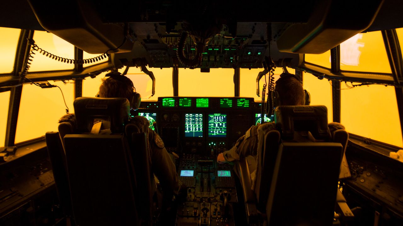 The flight deck of a C-130J Hercules is lit by the red glow of the fires below as the aircrew attempts to land in Merimbula to drop off fire and rescue crews to assist fighting the bushfires on January 5.