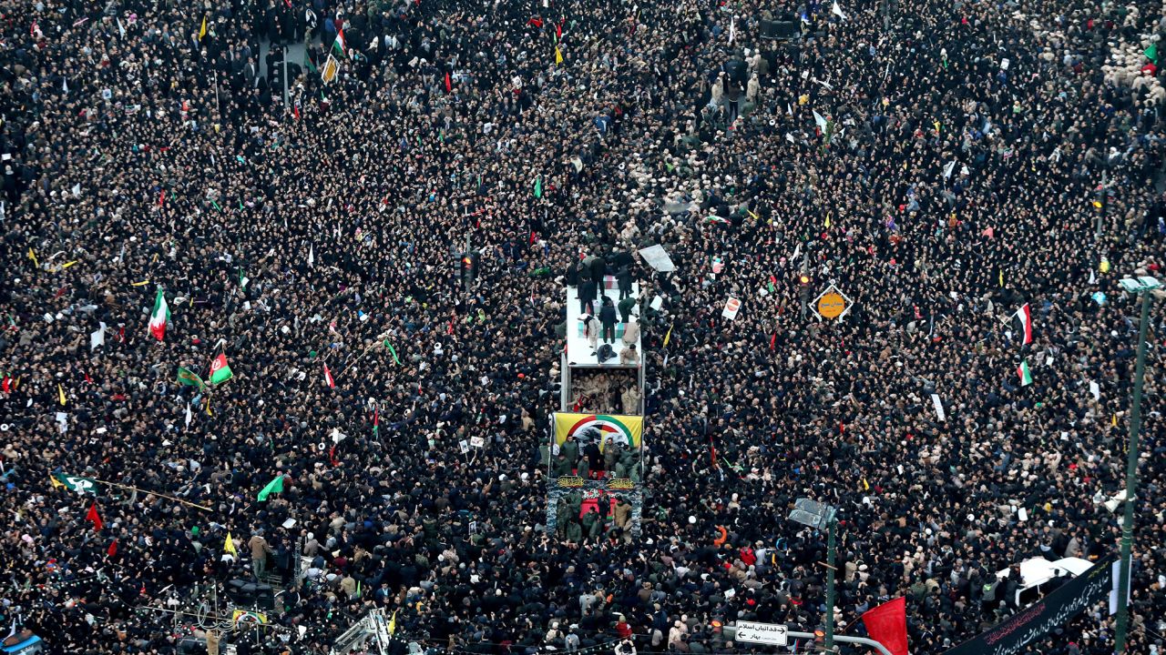 Coffins of Gen. Qassem Soleimani and his comrades who were killed in Iraq by a U.S. drone strike, are carried on a truck surrounded by mourners during a funeral procession, in the city of Mashhad, Iran, Sunday, Jan. 5, 2020. Soleimani's death Friday in Iraq further heightens tensions between Tehran and Washington after months of trading attacks and threats that put the wider Middle East on edge. (Mohammad Hossein Thaghi/Tasnim News Agency via AP)