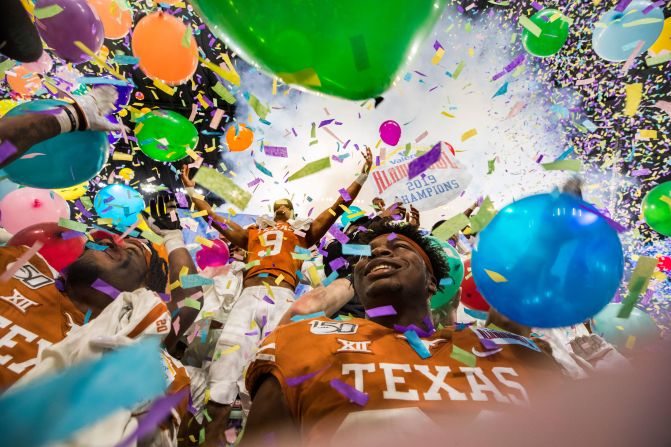 Texas football players celebrate their Alamo Bowl victory over Utah on Tuesday, December 31.
