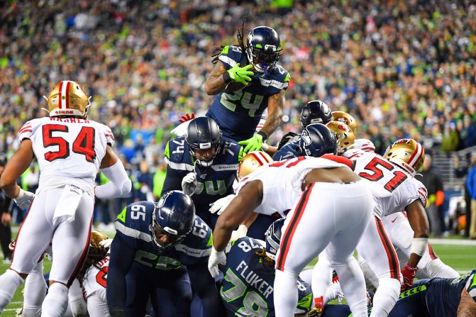 Seattle running back Marshawn Lynch, playing his first game since <a href="index.php?page=&url=https%3A%2F%2Fwww.cnn.com%2F2019%2F12%2F24%2Fus%2Fseahawks-sign-marshawn-lynch-spt-trnd%2Findex.html" target="_blank">coming out of retirement,</a> leaps for a touchdown against San Francisco on Sunday, December 29.