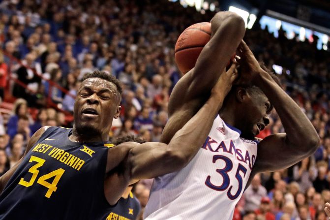 West Virginia's Oscar Tshiebwe and Kansas' Udoka Azubuike battle for the ball during a college basketball game in Lawrence, Kansas, on Saturday, January 4.
