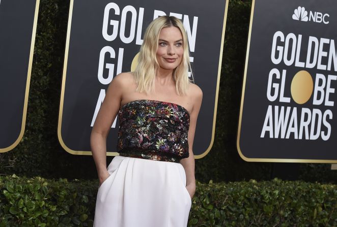 Margot Robbie wore a strapless top with a floor-length white skirt.