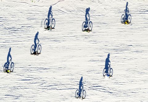 This aerial photo, taken with a drone, shows cyclists taking part in the St. Sylvestre Grand Prix, a mountain bike race in Villars-sur-Ollon, Switzerland, on Tuesday, December 31.