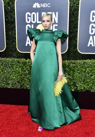 "Killing Eve" star Jodie Comer arrived in an eye-catching emerald dress with exaggerated shoulders.