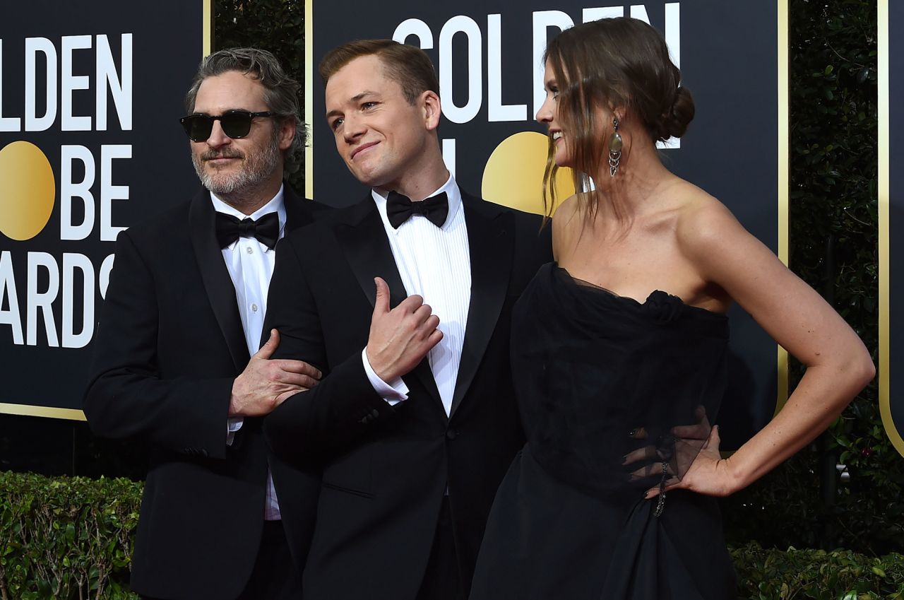 From left, Joaquin Phoenix, Taron Egerton and Emily Thomas
