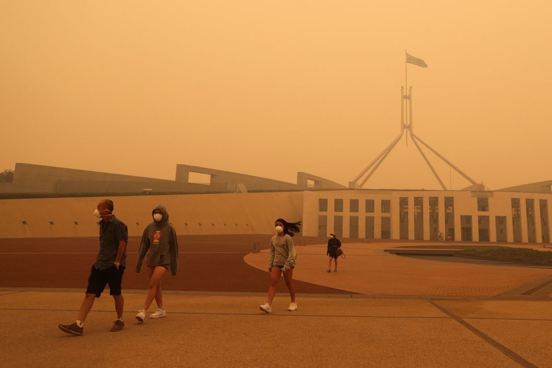 Visitors to Parliament House were forced to wear face masks after smoke from bushfires blankets Canberra in a haze on January 5.