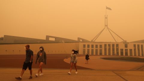 Visitors to Parliament House were forced to wear face masks after smoke from bushfires blankets Canberra in a haze on January 5.