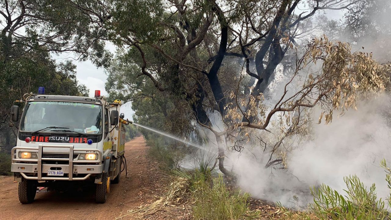 A firefighter is seen spraying water