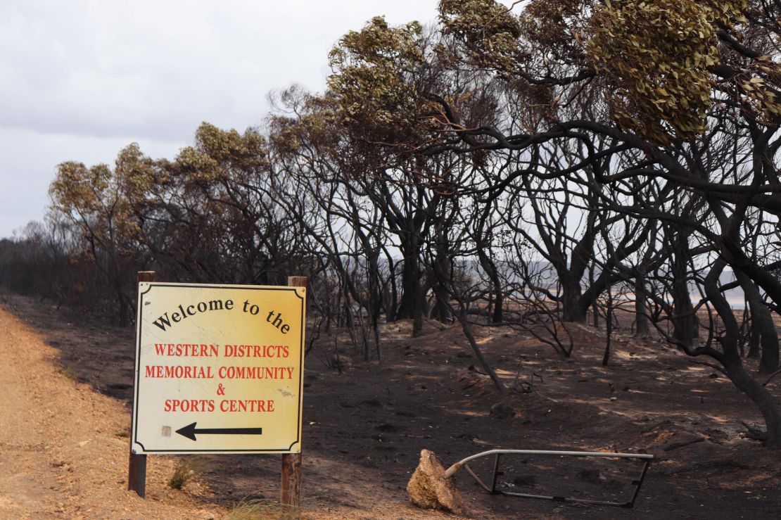 A sign stands next to burned land in Kangaroo Island