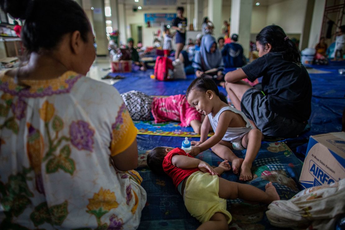 People are seen in a temporary shelter in Indonesia after the floods.