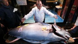 Kiyoshi Kimura, president of Kiyomura Co. center, poses with a tuna in front of one of the company's Sushi Zanmai restaurants after the year's first auction at Toyosu Market on January 05, 2020 in Tokyo, Japan. Kiyomura Co., which operates the Sushi Zanmai restaurant chain, purchased the tuna weighing 276 kilogram for 193.2 million yen at the year's first auction.