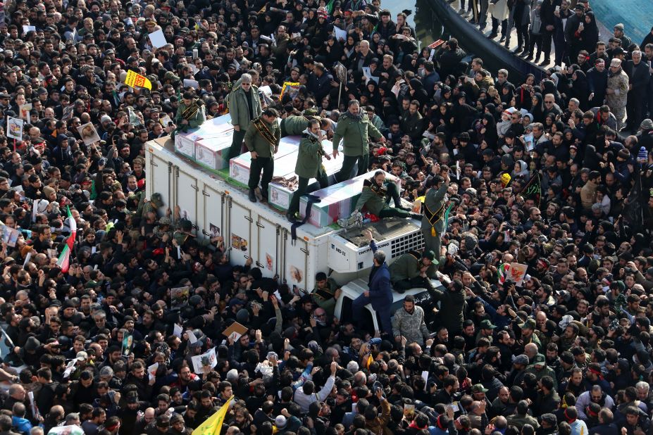 Revolutionary Guard members accompany the coffins.