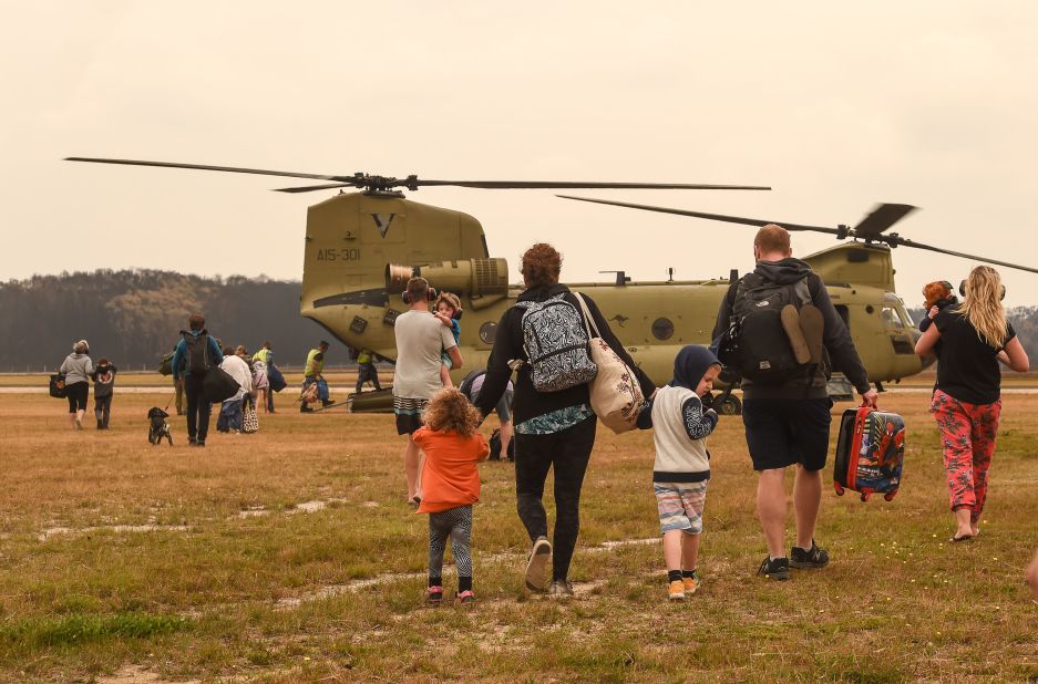 Families are evacuated by air from Mallacoota on January 5. 