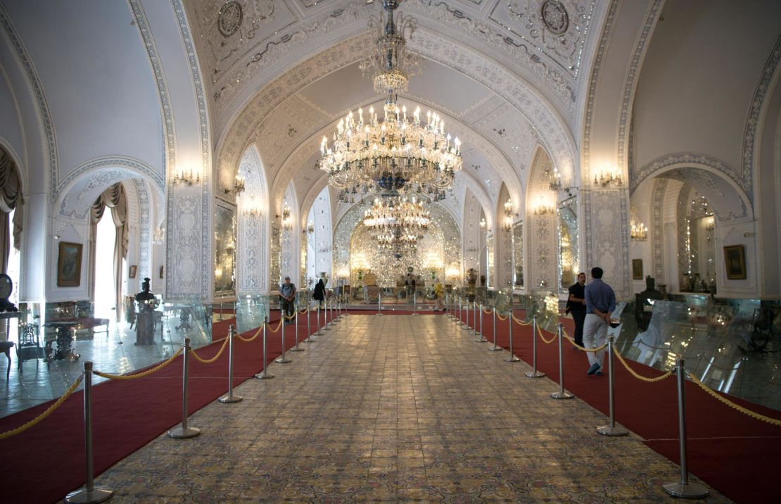 Tourists walk through a hall containing historical furnishings in the Golestan Palace in 2016. 