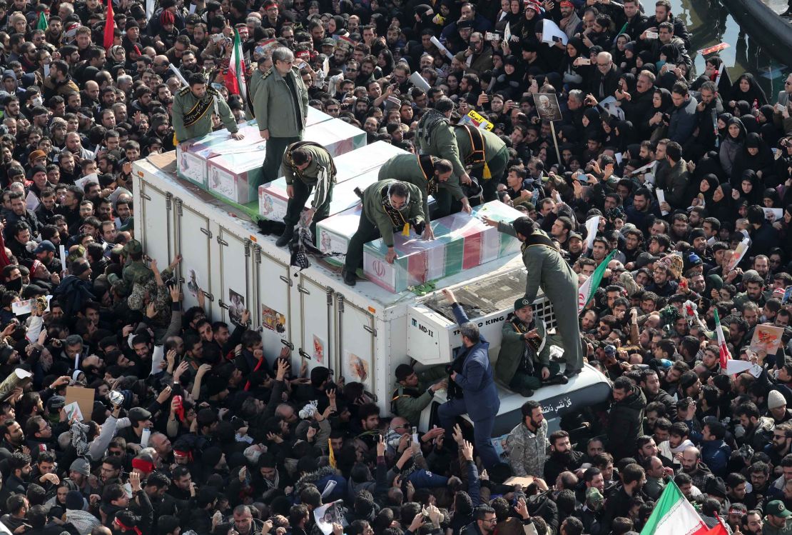 Iranian revolutionary guards surround the coffins of Soleimani and other victims during the procession.