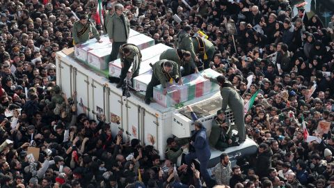 Iranian revolutionary guards surround the coffins of Soleimani and other victims during the procession.