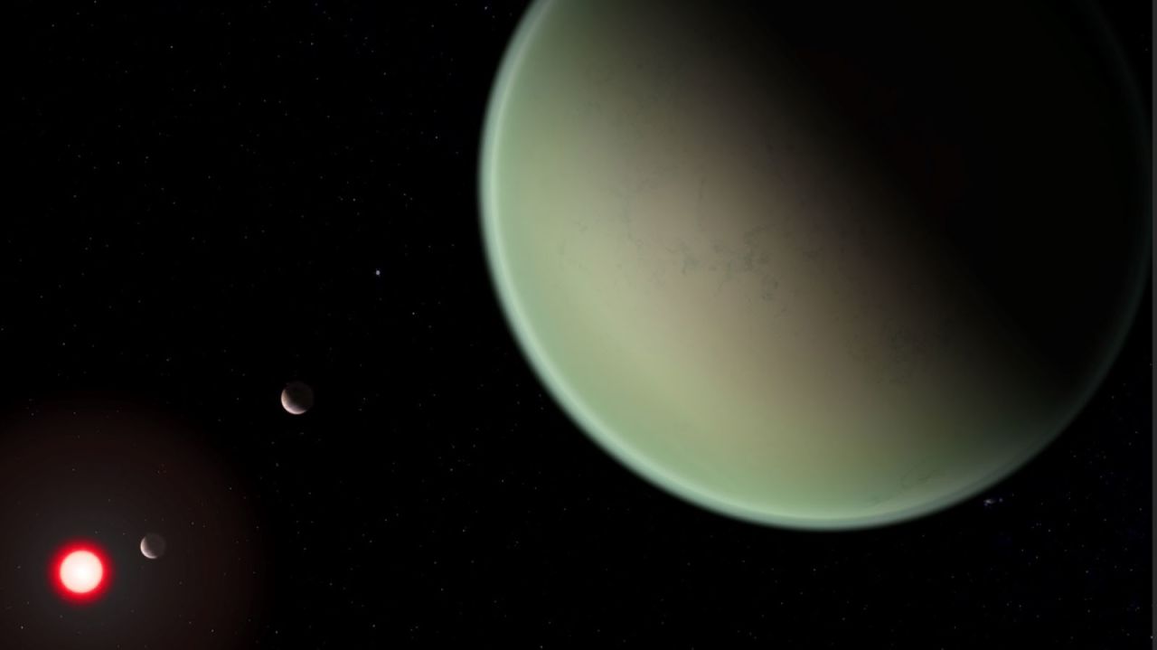 This artist's illustration shows a dry exoplanet with an oxygen atmosphere. The red sphere is the M-dwarf star the exoplanet orbits.